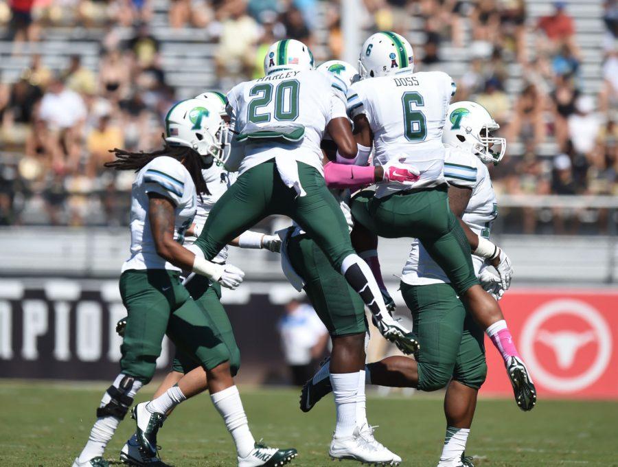 Sophomore linebacker Nico Marley and junior cornerback Lorenzo Doss celebrate a defensive stop in a 20-13 loss against Central Florida Saturday, Oct. 18. Doss was selected in the fifth round of the 2015 NFL Draft by the Denver Broncos. Doss dialed up 15 interceptions in his three-year collegiate career with the Green Wave. 