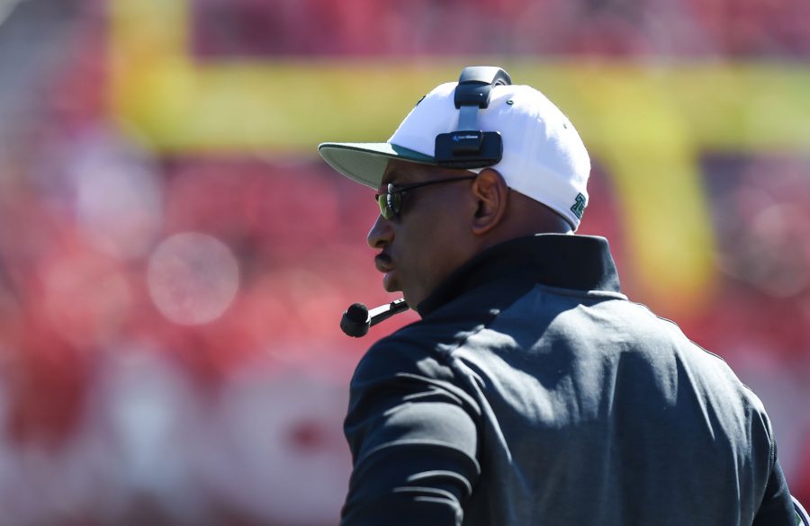 Football head coach Curtis Johnson pacing the sidelines in the 31-6 loss against Rutgers Sept. 27, in Piscataway, New Jersey. Johnson consistently wears the black sunglass, flat-rim hat look each game.  