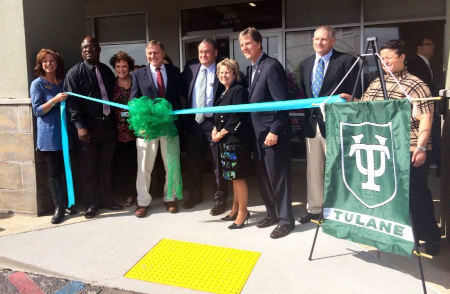 President Michael Fitts helps cut the ribbon to commemorate Tulanes new Biloxi, Mississippi campus. Tulane converted a book store into a space for the School of Continuing Studies.