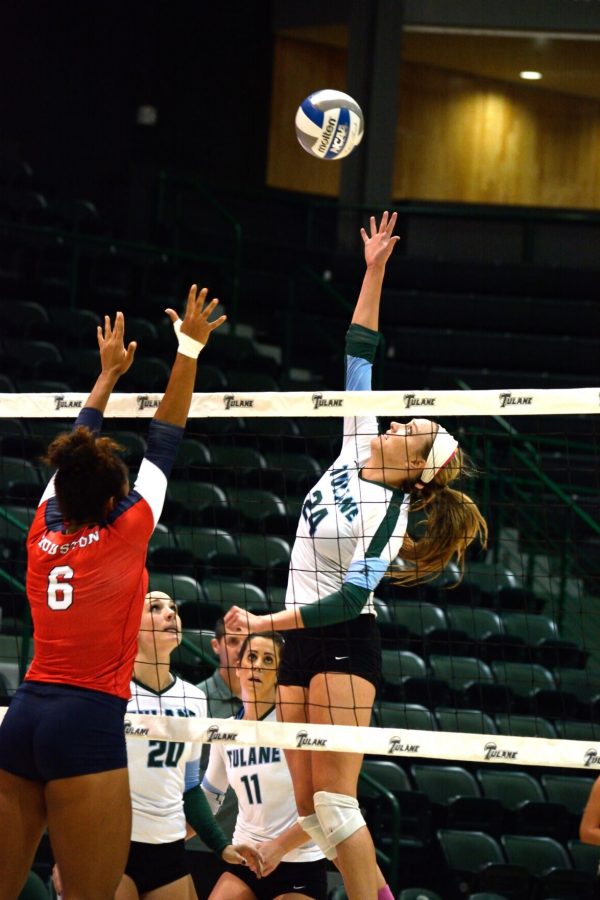 Tulane junior middle blocker Sarah Strasner jumps to spike ball in a 3-2 loss against Houston as redshirt freshman middle blocker Chenelle Walker attempts to block the hit. 