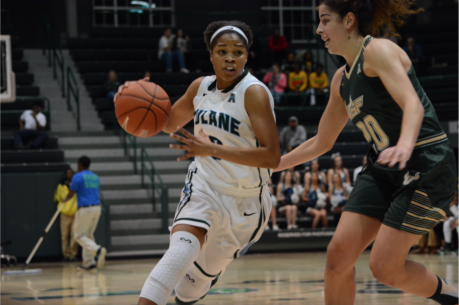 Sophomore guard Kolby Morgan makes a press toward the basket as USFs sophomore forward Laura Ferreira attempts to block the advance during the Green Waves loss against USF (67-71) on Jan. 13 in Devlin Field house. 