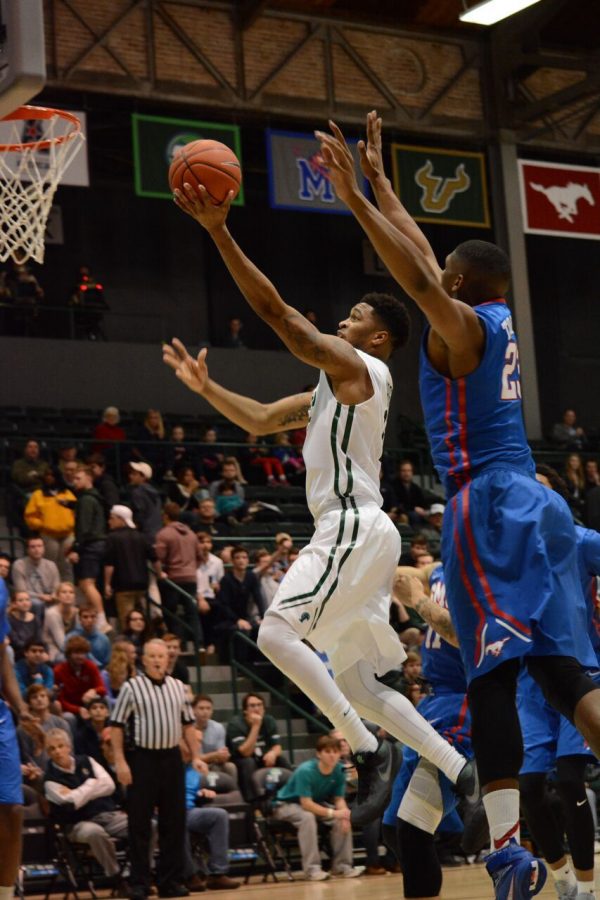 Redshirt junior Malik Morgan goes in for a layup during Sundays matchup against SMU. Morgan finished the game with 10 points but could not lift the Green Wave past the undefeated Mustangs.