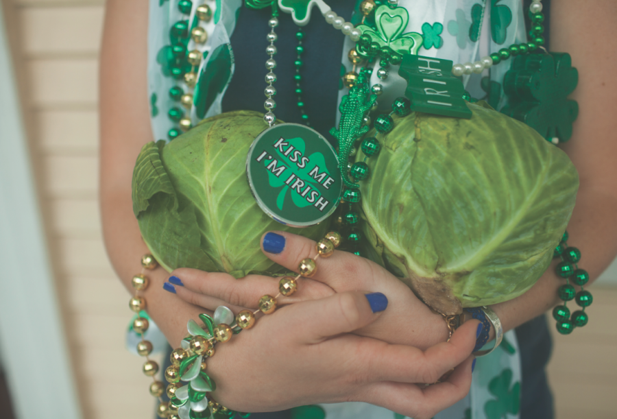 Decked out in holiday attire, a St. Patricks Day celebrator shows off her parade throws. 