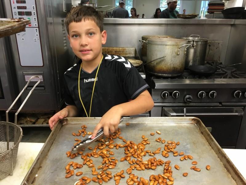 Chopped Junior champion Kaj Friis-Hecht makes candied almonds in the HK Nola kitchen.