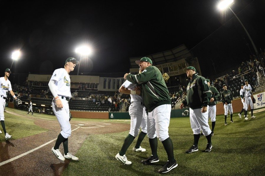 Head coach Travis Jewett celebrates with his team in a game against the Purdue Boilermakers. This is Jewett’s second season as head coach of the Green Wave.