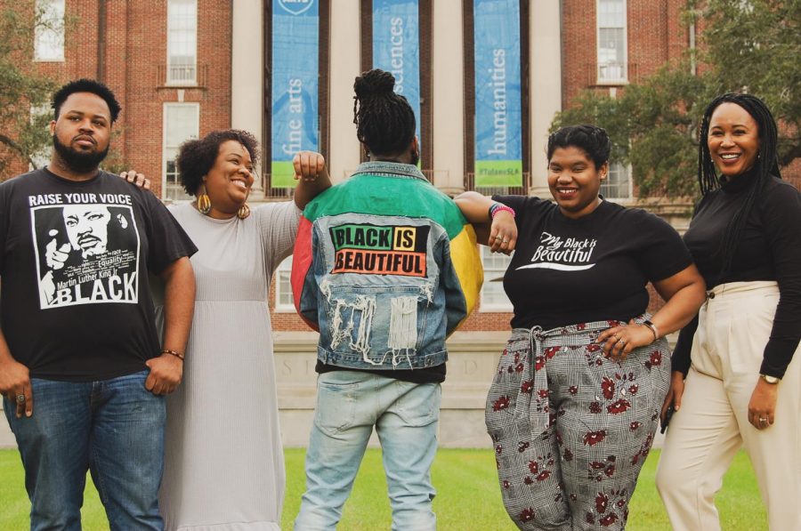 Carl Briggs, Inas Shabazz, Justin Taylor, Maiya Tate, Janelle Williams pose in front of Newcomb Hall. 