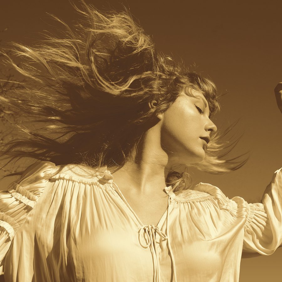 taylor swift swinging her hair in sepia