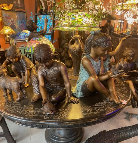 photo of antique statues of children and lamps