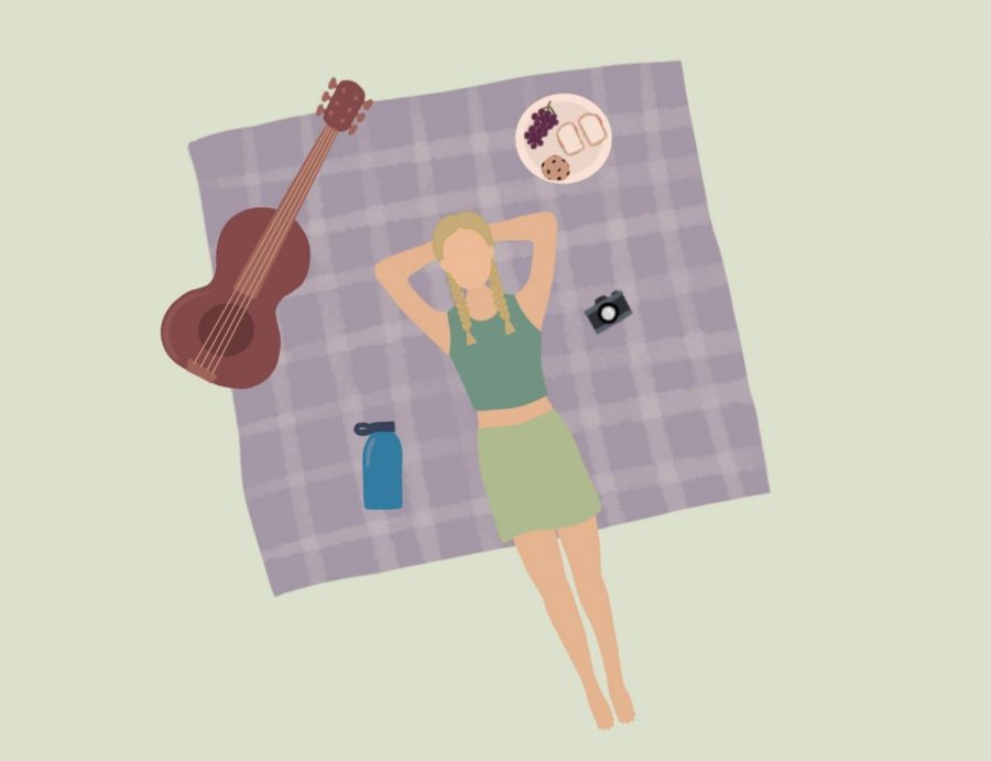 girl laying on picnic blanket with guitar and food to have fun
