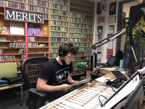 student dj sits in front of microphone to host a section of the marathon in the wtul office