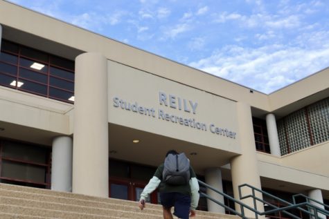 reily with student walking up stairs