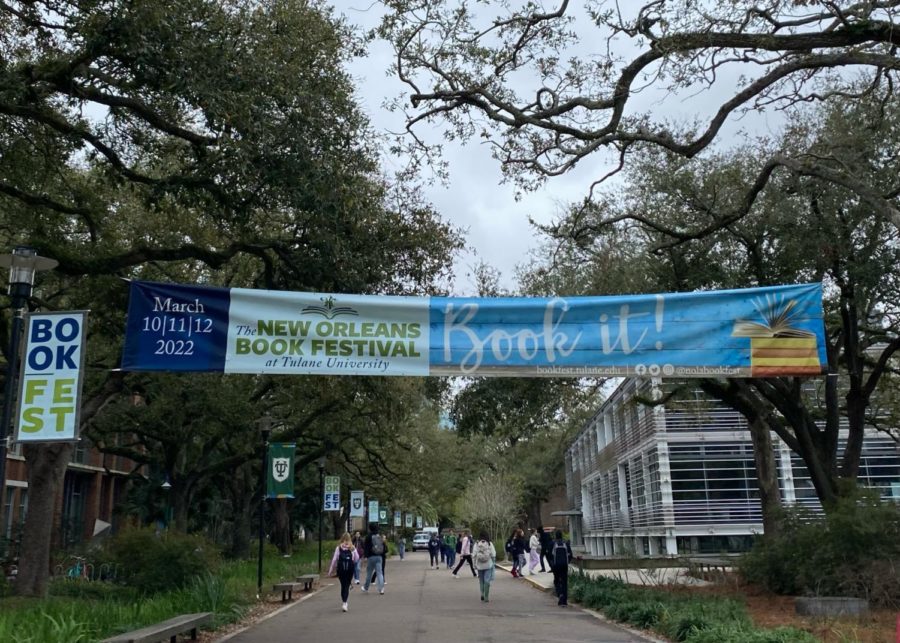 A sign advertising the New Orleans Book Festival hangs over McAlister Place. 