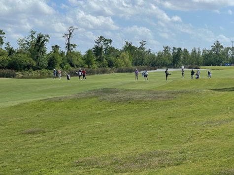 Two groups of golfers prepare to take their second shots on the 18th hole at TPC Louisiana on Friday, April 22.