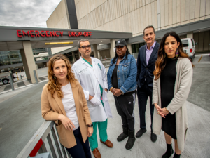 Julia Fleckman (far left), Dr. Sharven Taghavi (second from left), Joseph Constans (second from right) and coworkers help victims disrupt the cycle of gun violence at University Medical Center. 