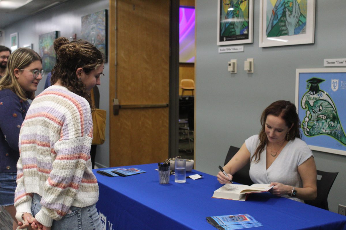 This years Zale-Kimmerling Writer-in-Residence, Rebecca Makkai, signing a copy of her novel “I Have Some Questions For You.”