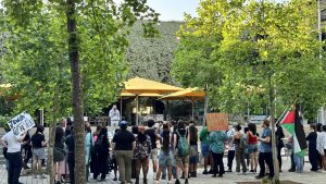 Professor Ata Hindi spoke to students gathered in Pocket Park Wednesday evening in protest of Hillel hosting a dinner with an IDF soldier. 