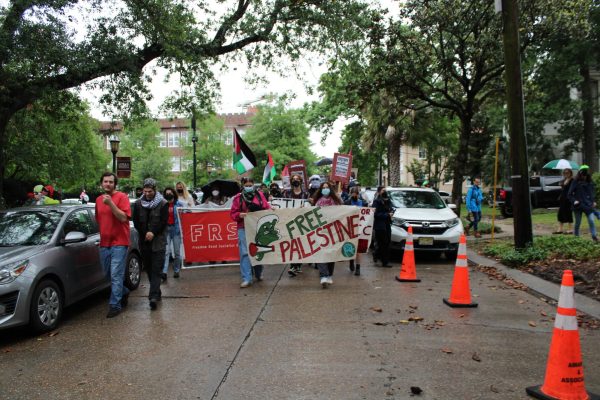 Pro-Palestinian protestors march up Calhoun Street before turning on St. Charles Avenue to protest outside of Gibson Hall on Monday evening. 