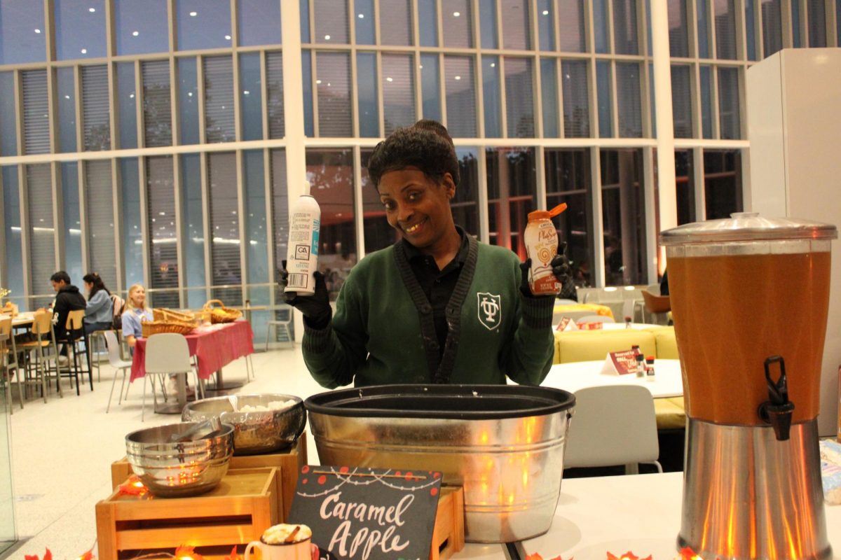 Employee at the Commons poses while serving desserts on the second floor.