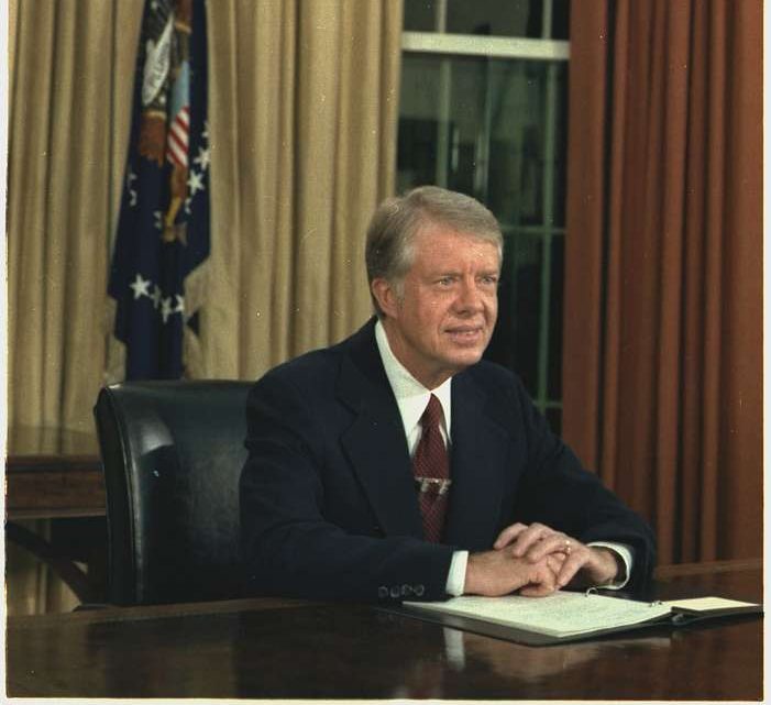 Jimmy Carter sits in the Oval Office. 