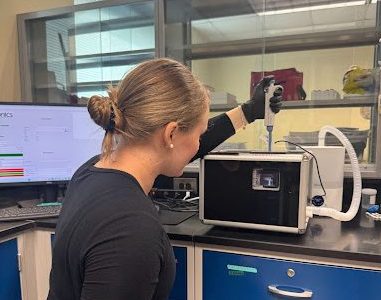 McKenzie Cummins demonstrating the injection into the standing acoustic field.