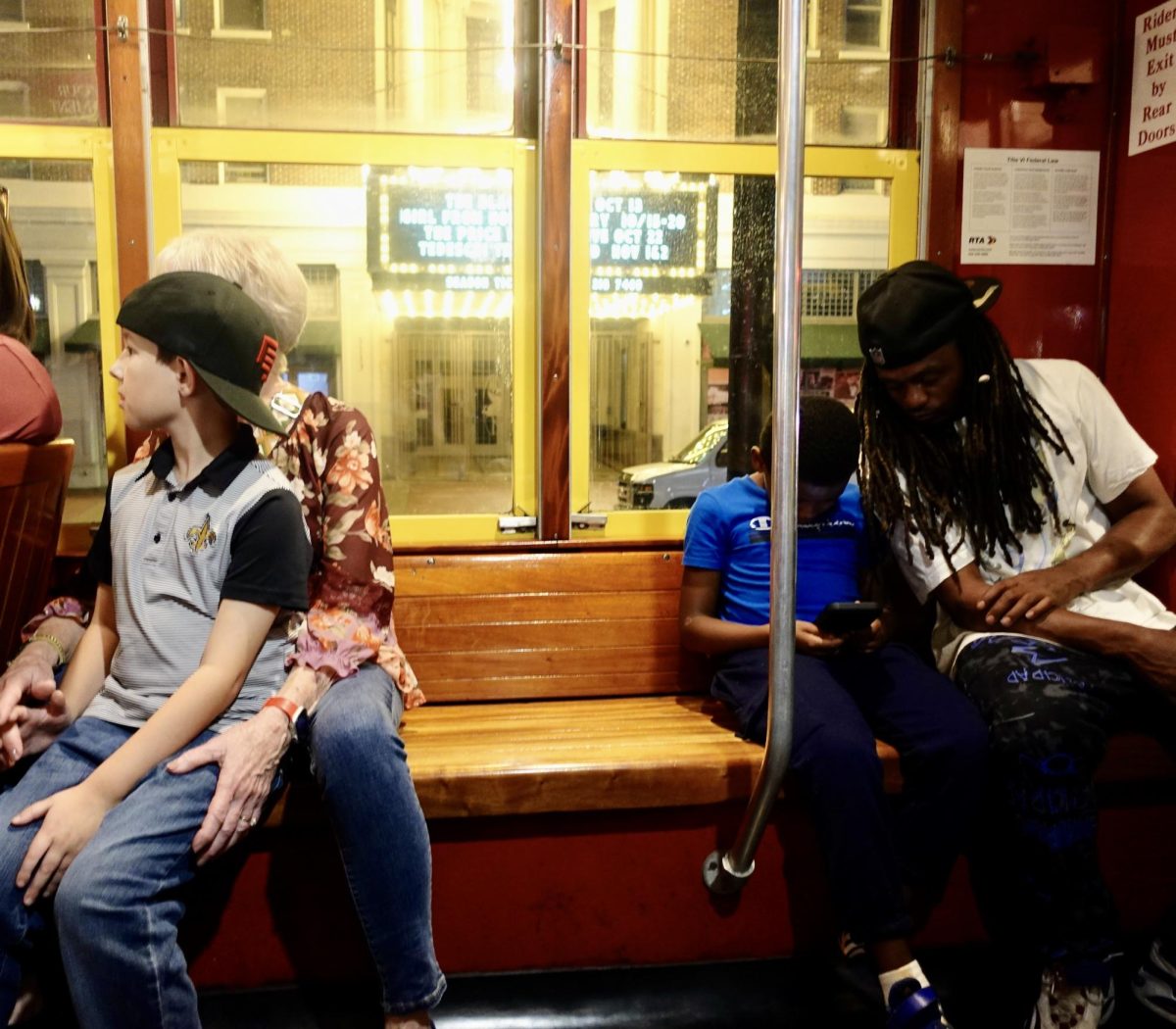   People ride the streetcar together.