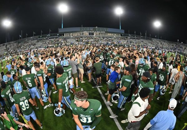 Students stormed the field, celebrating the Green Wave victory with players and staff.