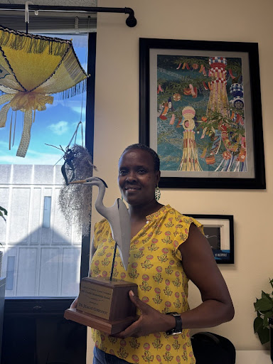 Dorothy Jelagat Cheruiyot PhD and her coastal stewardship award in her office.