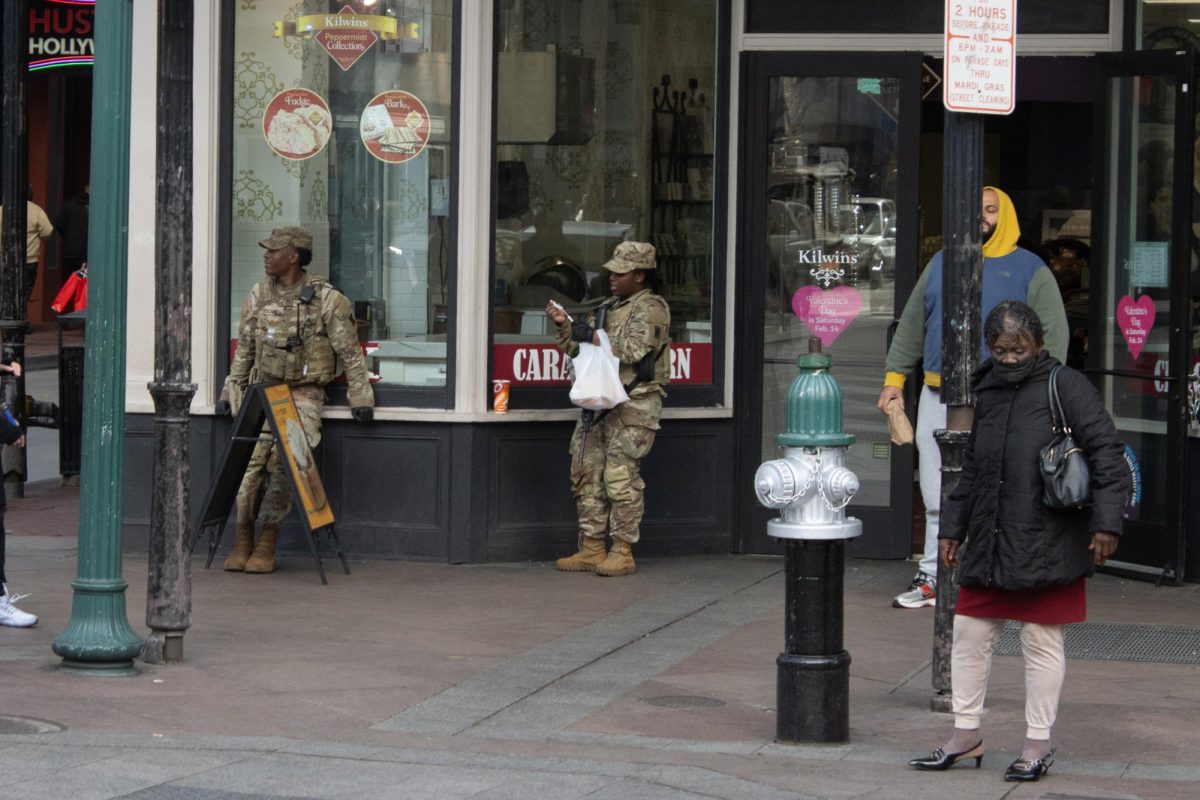 Soldiers from the Louisiana National Guard stand near the entrance to Bourbon Street