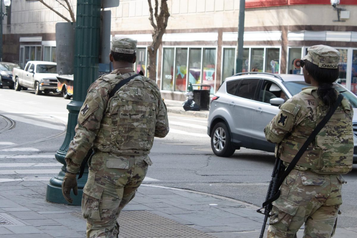 Two soldiers from the Louisiana National Guard cross Canal Street