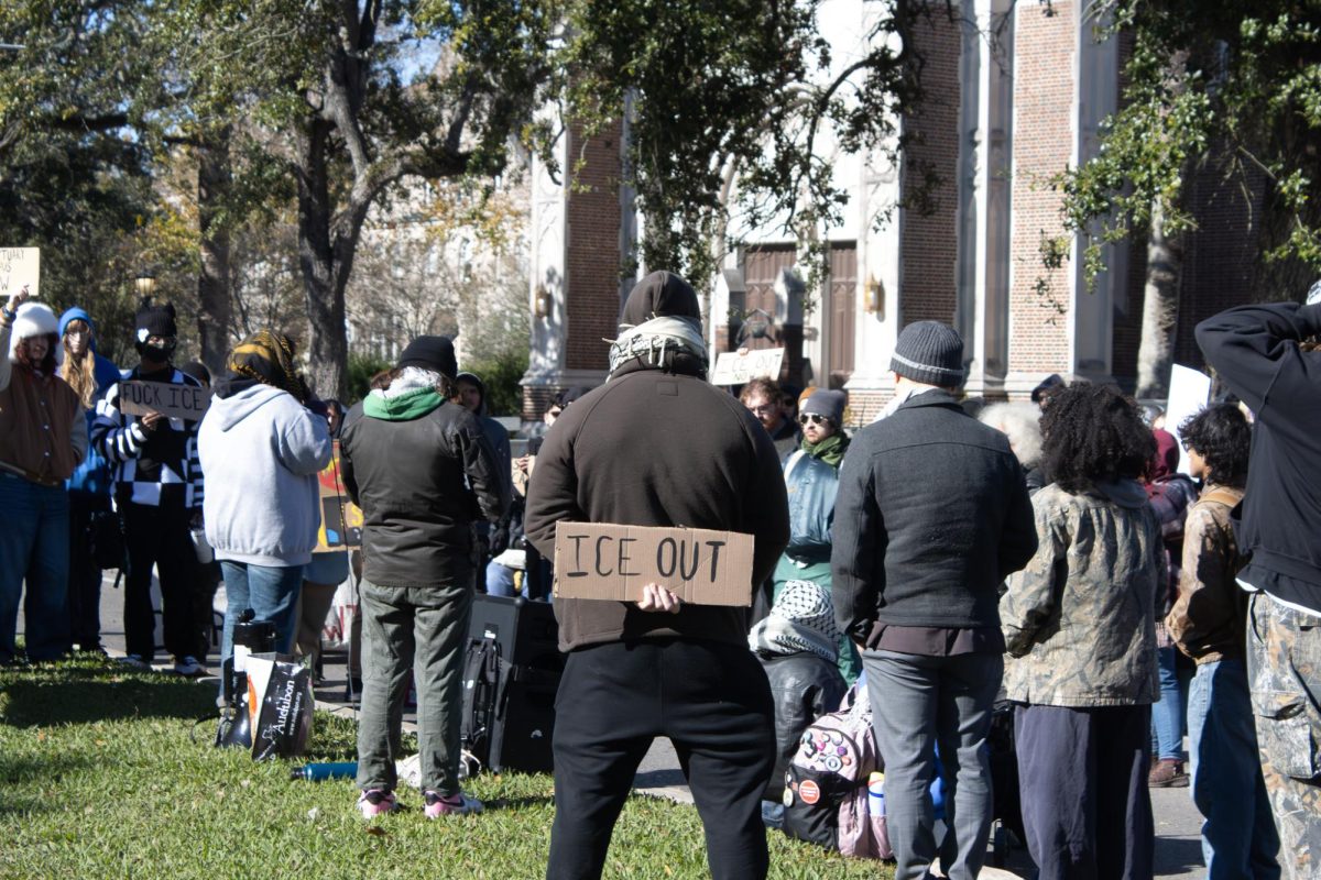 A protester holds a sign as demonstrators block St Charles Avenue