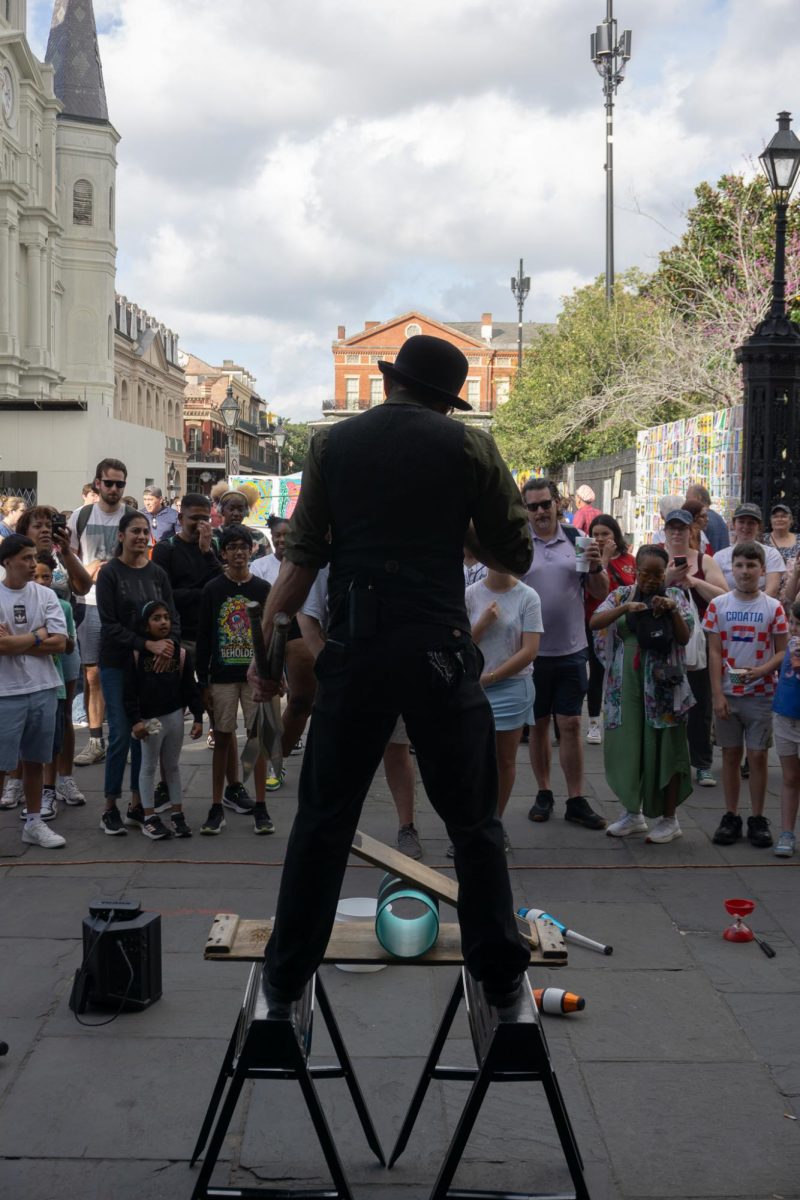 A juggler stands in front of a crowd right before his big finale.